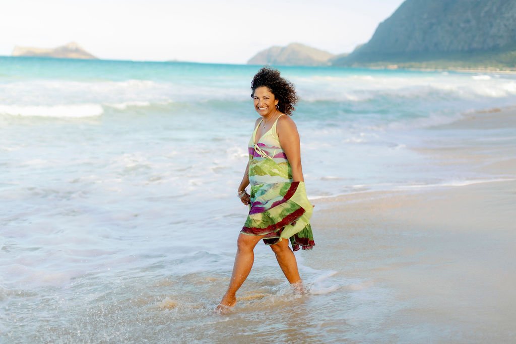 Reet German walking joyfully along the shoreline